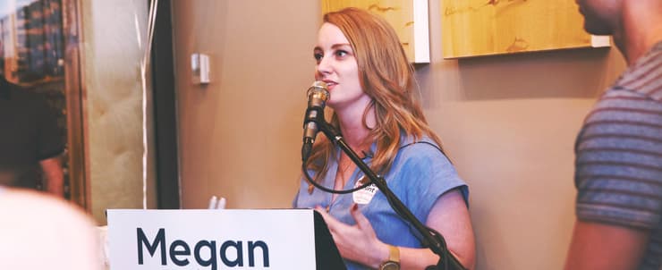 Megan, in front of the microphone.